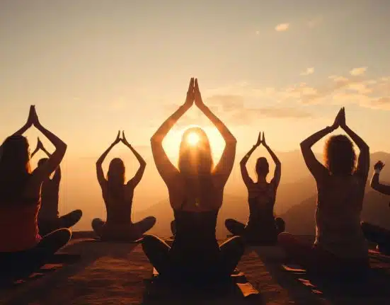 full shot people doing yoga together 23 2151084081